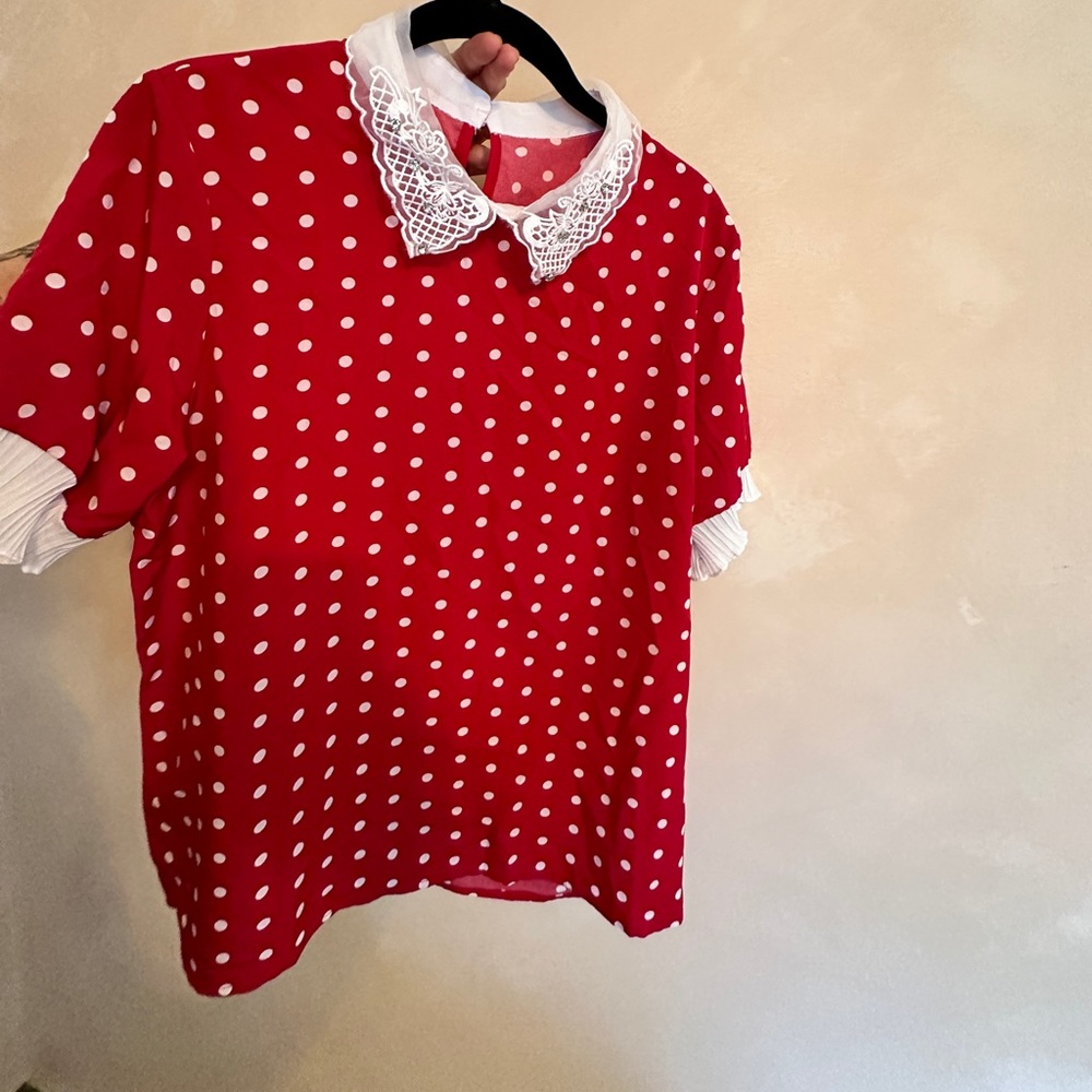 Vintage-style red polka dot blouse with rhinestone and frill neckline